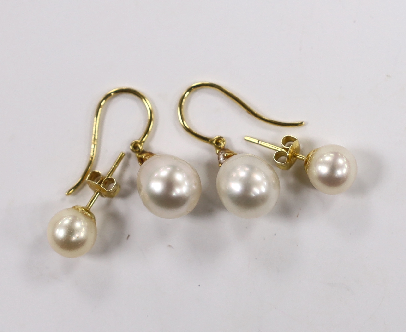 A pair of 18ct gold and cultured pearl and diamond chip set drop earrings and a pair of 18k and cultured pearl set ear studs.